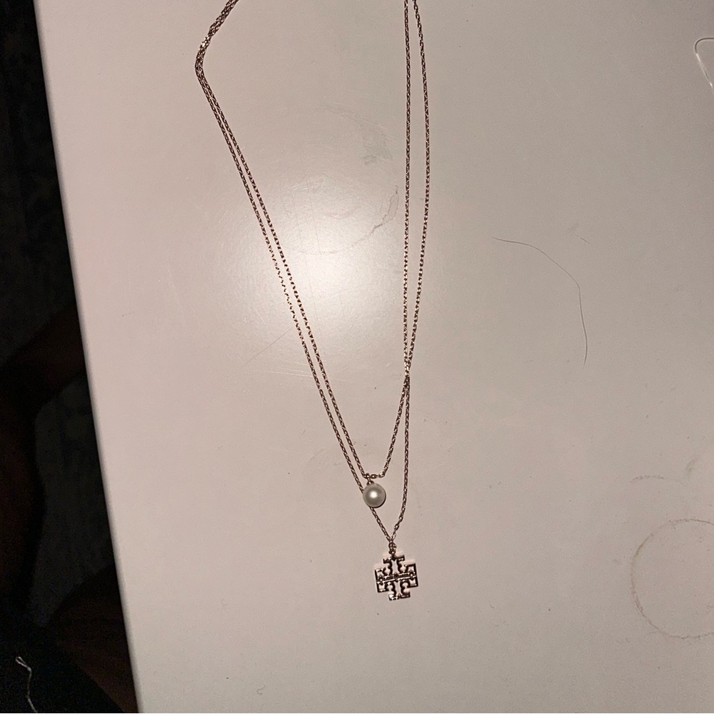 Tory Burch necklace. Gold logo with pearl accent bead. Beautiful. Never worn